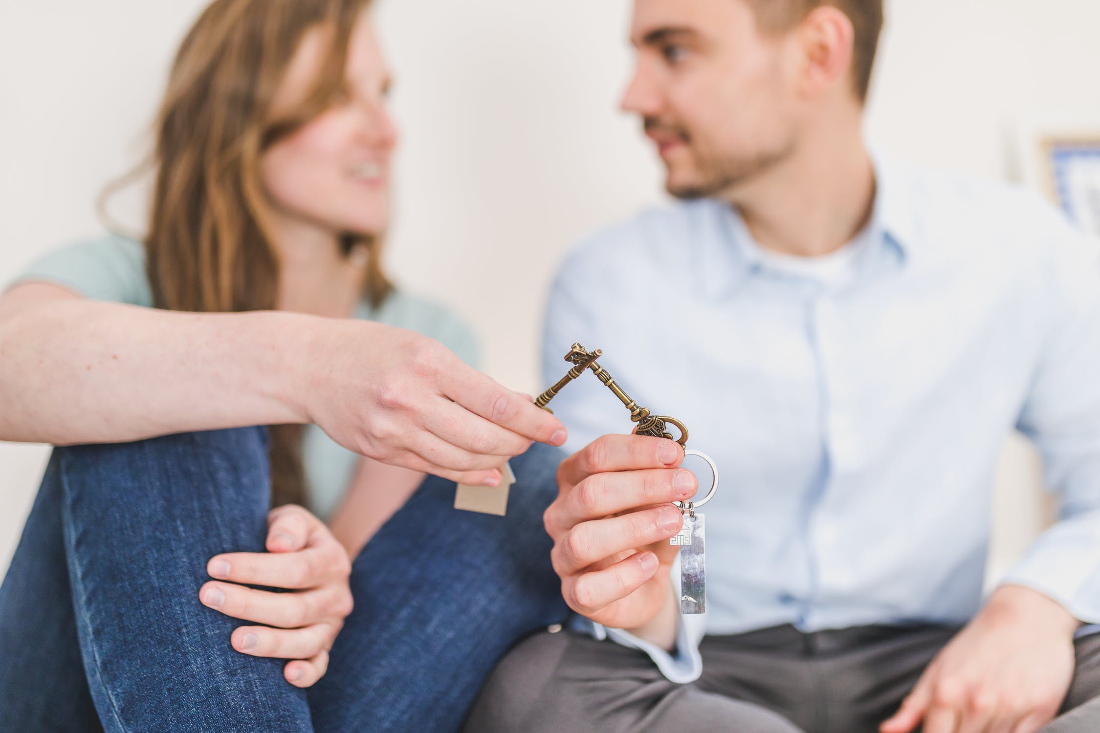 Man-and-woman-sitting-while-holding-keys